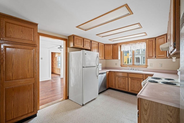 511 Ocean Ave, Wells, ME 04090 - kitchen with white appliances, light countertops, light floors, and brown cabinetry