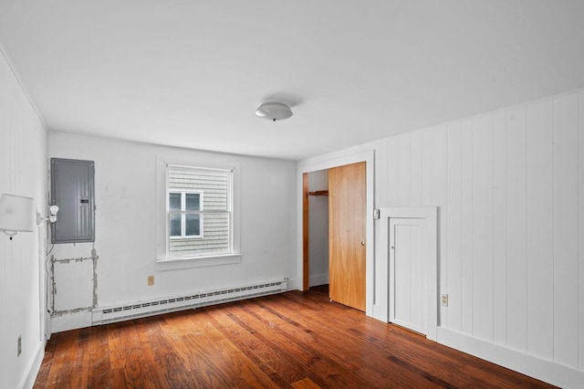 511 Ocean Ave, Wells, ME 04090 - unfurnished bedroom with electric panel, a baseboard heating unit, and hardwood / wood-style flooring