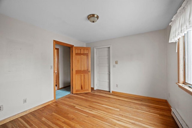 511 Ocean Ave, Wells, ME 04090 - unfurnished room featuring a baseboard radiator and light wood-style flooring