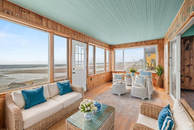 511 Ocean Ave, Wells, ME 04090 - sunroom with hardwood / wood-style flooring, wood walls, and a water view