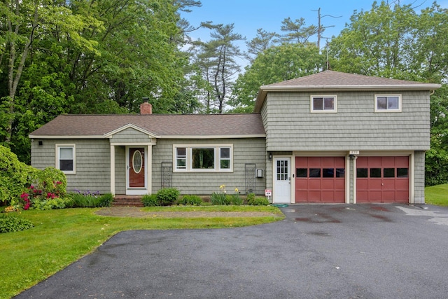 535 Spring St, Westbrook, ME 04092 - view of front of property with a chimney, driveway, a front yard, and roof with shingles