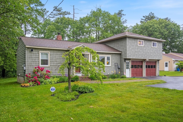 535 Spring St, Westbrook, ME 04092 - view of front of house with a chimney, driveway, an attached garage, a front lawn, and roof with shingles