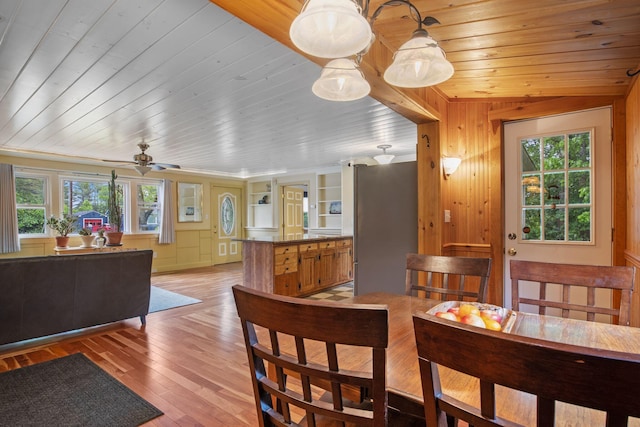 535 Spring St, Westbrook, ME 04092 - dining area with plenty of natural light, wood ceiling, light wood-style floors, a ceiling fan, and wooden walls