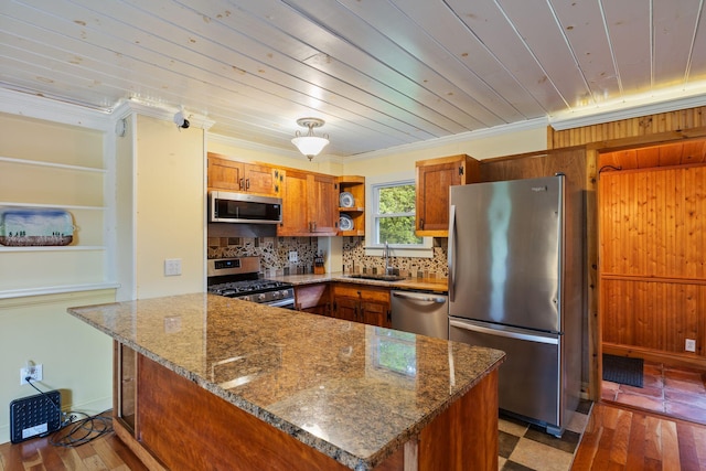 535 Spring St, Westbrook, ME 04092 - kitchen featuring stainless steel appliances, open shelves, a sink, brown cabinets, and a peninsula