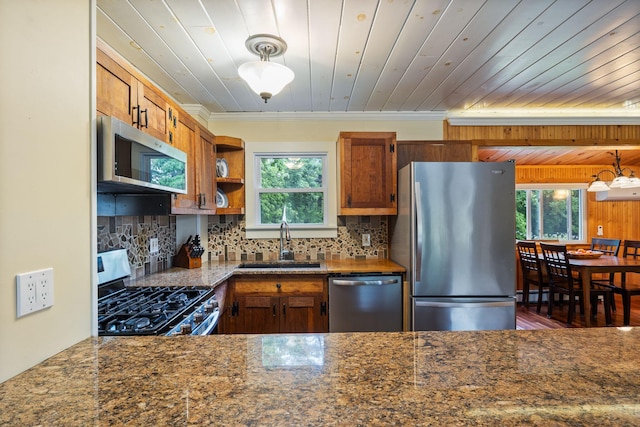 535 Spring St, Westbrook, ME 04092 - kitchen with appliances with stainless steel finishes, a sink, plenty of natural light, backsplash, and crown molding