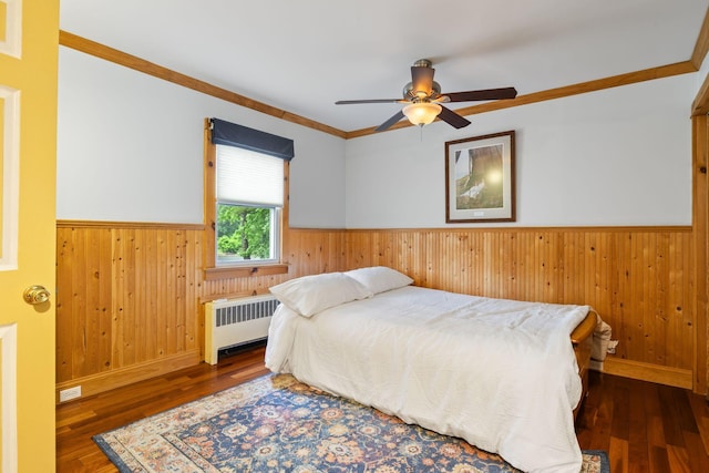 535 Spring St, Westbrook, ME 04092 - bedroom featuring radiator, a wainscoted wall, wood walls, wood-type flooring, and crown molding