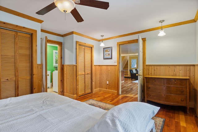 535 Spring St, Westbrook, ME 04092 - bedroom featuring wainscoting, hardwood / wood-style flooring, two closets, independent washer and dryer, and crown molding