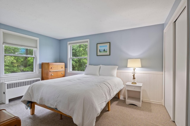 535 Spring St, Westbrook, ME 04092 - bedroom with radiator heating unit, carpet floors, a wainscoted wall, and a closet