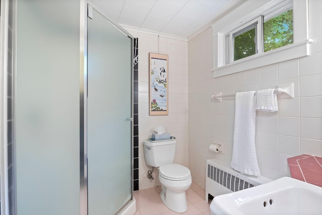 535 Spring St, Westbrook, ME 04092 - bathroom featuring tile walls, radiator heating unit, a stall shower, tile patterned flooring, and toilet
