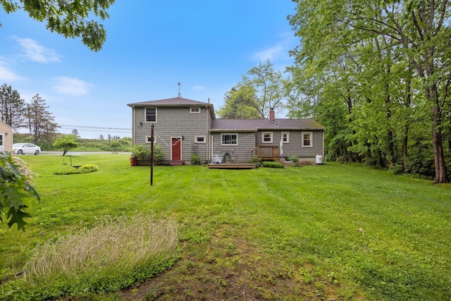 535 Spring St, Westbrook, ME 04092 - back of property featuring a lawn, a deck, and a chimney