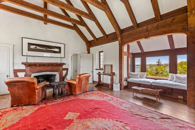 1392 N Haven Rd, Vinalhaven, ME 04863 - living room with high vaulted ceiling, wood finished floors, a lit fireplace, and beamed ceiling