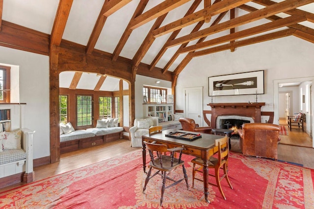 1392 N Haven Rd, Vinalhaven, ME 04863 - dining room with a lit fireplace, high vaulted ceiling, wood finished floors, plenty of natural light, and beam ceiling