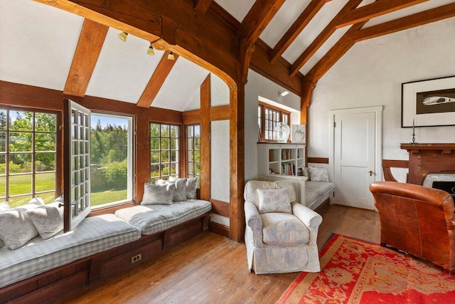 1392 N Haven Rd, Vinalhaven, ME 04863 - living room featuring beam ceiling, hardwood / wood-style floors, high vaulted ceiling, and a fireplace