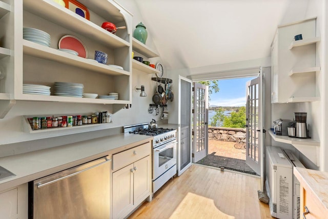1392 N Haven Rd, Vinalhaven, ME 04863 - kitchen featuring appliances with stainless steel finishes, open shelves, light wood-style floors, light countertops, and lofted ceiling