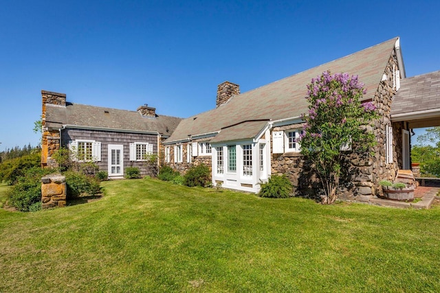 1392 N Haven Rd, Vinalhaven, ME 04863 - back of house with a lawn, stone siding, french doors, and a chimney