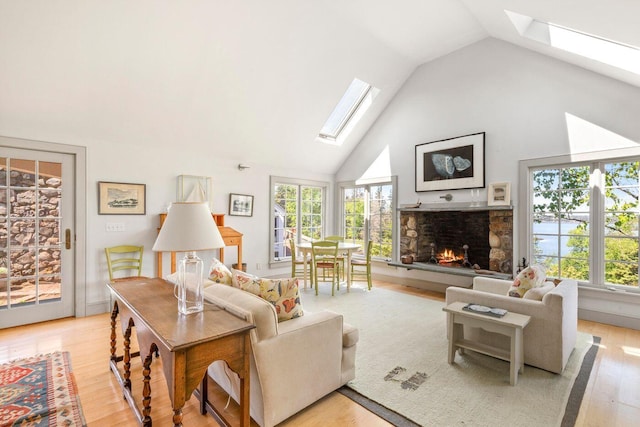 1392 N Haven Rd, Vinalhaven, ME 04863 - living area with a skylight, healthy amount of natural light, light wood-type flooring, and high vaulted ceiling