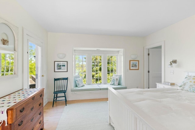 1392 N Haven Rd, Vinalhaven, ME 04863 - bedroom with multiple windows, access to exterior, and light wood-style flooring