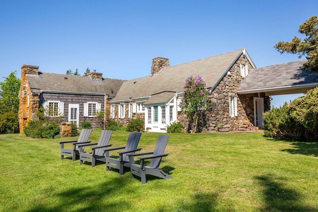 1392 N Haven Rd, Vinalhaven, ME 04863 - rear view of house with stone siding, a yard, and french doors