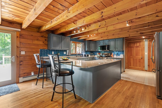 324 Pleasant Pond Rd, Turner, ME 04282 - kitchen with appliances with stainless steel finishes, a baseboard radiator, a peninsula, healthy amount of natural light, and a wood ceiling with exposed beams