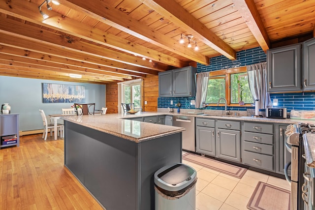 324 Pleasant Pond Rd, Turner, ME 04282 - kitchen with gray cabinetry, track lighting, stainless steel appliances, a peninsula, and a wooden ceiling with exposed beams