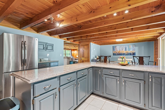 324 Pleasant Pond Rd, Turner, ME 04282 - kitchen with freestanding refrigerator, gray cabinetry, a wooden ceiling with exposed beams, light tile patterned flooring, and light stone countertops