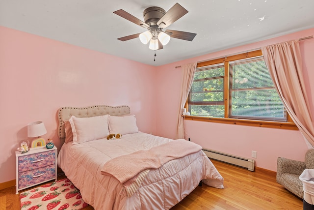 324 Pleasant Pond Rd, Turner, ME 04282 - bedroom with a baseboard radiator, wood finished floors, and a ceiling fan