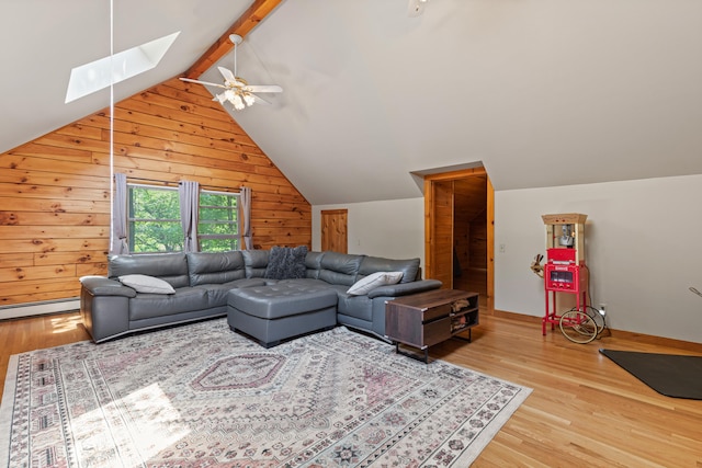 324 Pleasant Pond Rd, Turner, ME 04282 - living room featuring a skylight, wood walls, wood finished floors, ceiling fan, and a baseboard heating unit