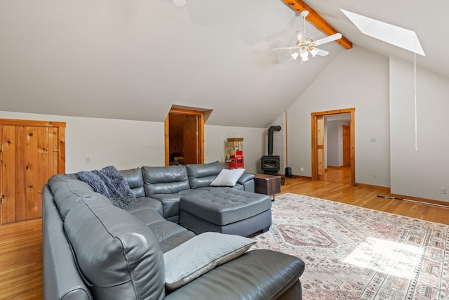 324 Pleasant Pond Rd, Turner, ME 04282 - living area featuring a skylight, a wood stove, light wood-type flooring, and a ceiling fan