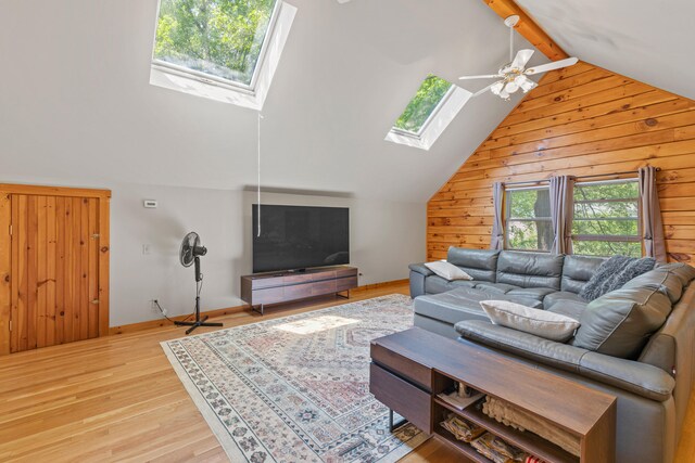 324 Pleasant Pond Rd, Turner, ME 04282 - living area featuring a skylight, wooden walls, ceiling fan, and light wood finished floors