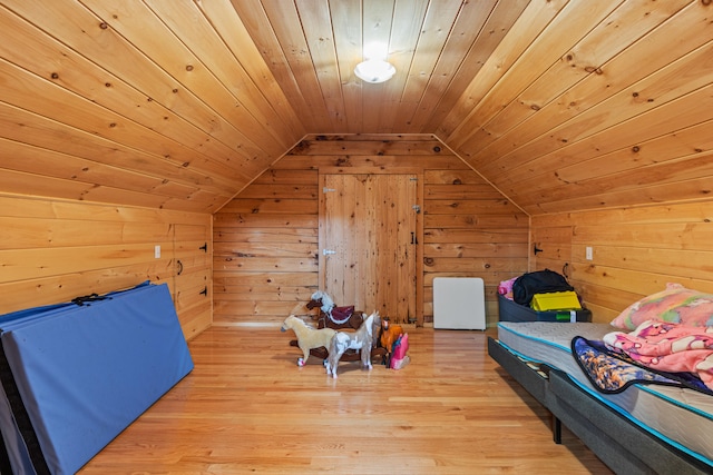 324 Pleasant Pond Rd, Turner, ME 04282 - bedroom featuring lofted ceiling, wooden walls, wood ceiling, and light wood-type flooring