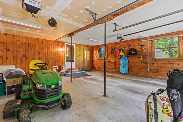 324 Pleasant Pond Rd, Turner, ME 04282 - garage featuring a garage door opener and wood walls
