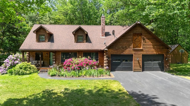 324 Pleasant Pond Rd, Turner, ME 04282 - cabin featuring driveway, log exterior, covered porch, and a front lawn