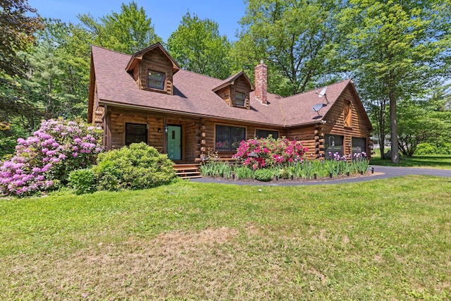 324 Pleasant Pond Rd, Turner, ME 04282 - cabin featuring log exterior, a chimney, covered porch, and a front lawn