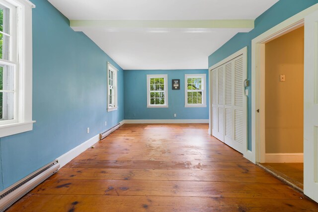 419 River Rd, Newcastle, ME 04553 - unfurnished bedroom with baseboard heating, beamed ceiling, hardwood / wood-style flooring, and a closet