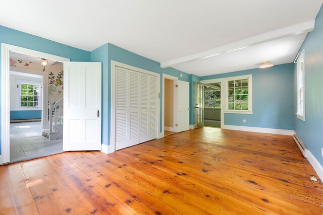 419 River Rd, Newcastle, ME 04553 - unfurnished bedroom with a baseboard radiator, hardwood / wood-style floors, and beam ceiling