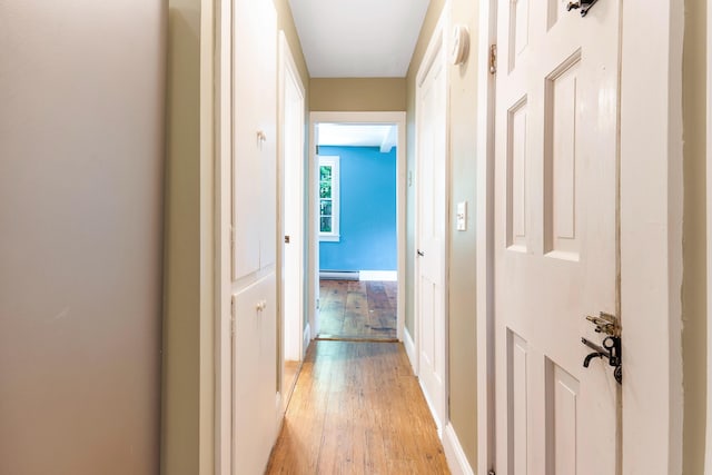 419 River Rd, Newcastle, ME 04553 - hallway featuring light wood finished floors and a baseboard radiator