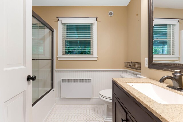 419 River Rd, Newcastle, ME 04553 - full bathroom with radiator, a wainscoted wall, vanity, and enclosed tub / shower combo