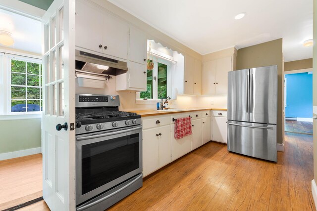 419 River Rd, Newcastle, ME 04553 - kitchen featuring stainless steel appliances, under cabinet range hood, light wood-type flooring, and white cabinets