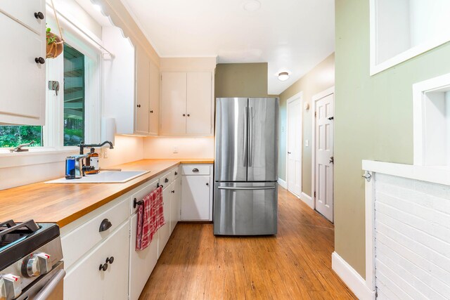 419 River Rd, Newcastle, ME 04553 - kitchen with stainless steel appliances, light wood finished floors, white cabinets, and butcher block countertops