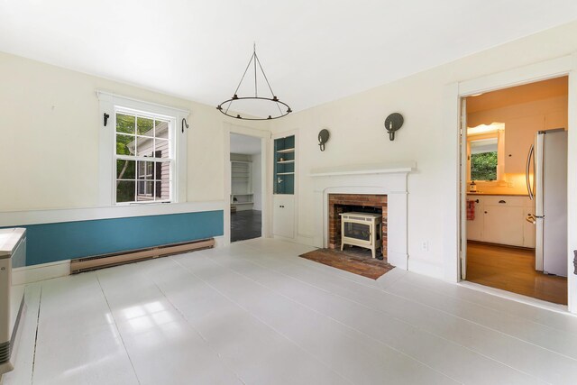 419 River Rd, Newcastle, ME 04553 - unfurnished living room with a baseboard radiator and built in features