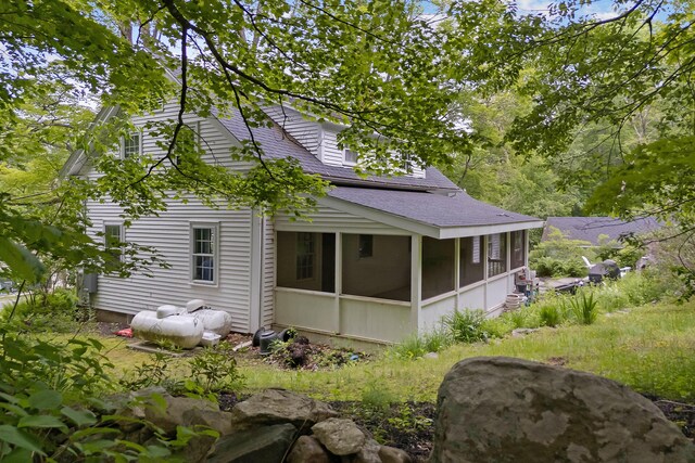 419 River Rd, Newcastle, ME 04553 - view of property exterior featuring a sunroom and roof with shingles