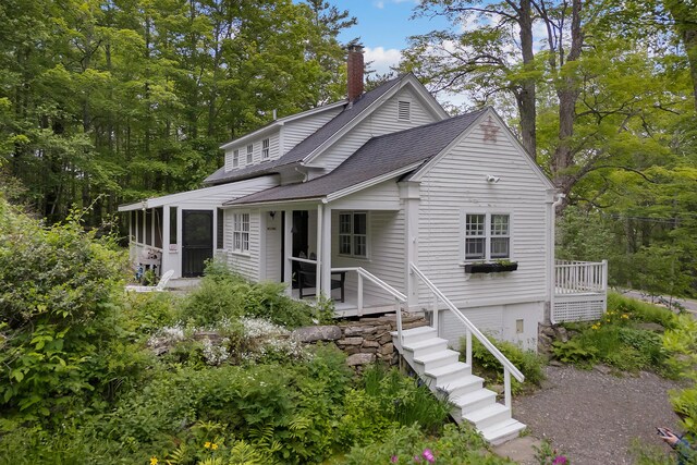 419 River Rd, Newcastle, ME 04553 - view of front of property with a sunroom, a shingled roof, a chimney, and stairway