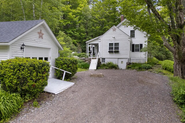 419 River Rd, Newcastle, ME 04553 - view of home's exterior with a shingled roof, a chimney, stairway, an outbuilding, and an attached garage