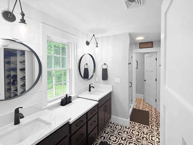 132 Mineral Spring Rd Unit 1, Windham, ME 04062 - full bath with double vanity, healthy amount of natural light, a closet, and tile patterned flooring