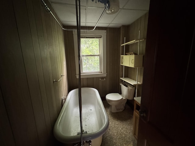 95 Eastern Ave, Augusta, ME 04330 - bathroom featuring a tub, wood walls, and toilet