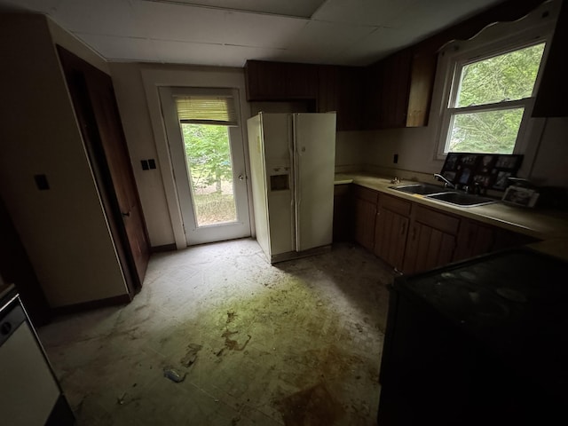 95 Eastern Ave, Augusta, ME 04330 - kitchen featuring white fridge with ice dispenser, a sink, black stove, light countertops, and baseboards