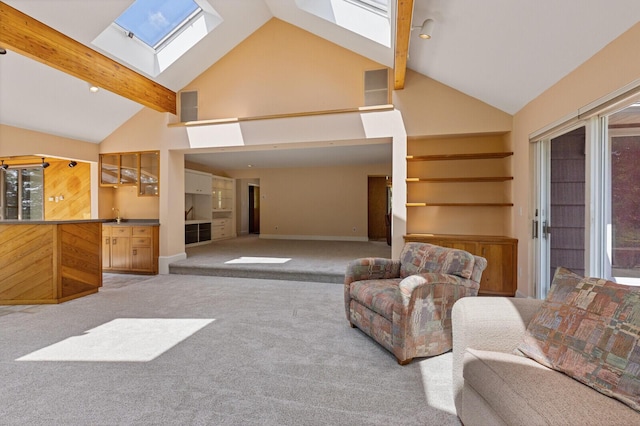 24 High St, Hallowell, ME 04347 - carpeted living area with a skylight, beamed ceiling, plenty of natural light, high vaulted ceiling, and built in shelves