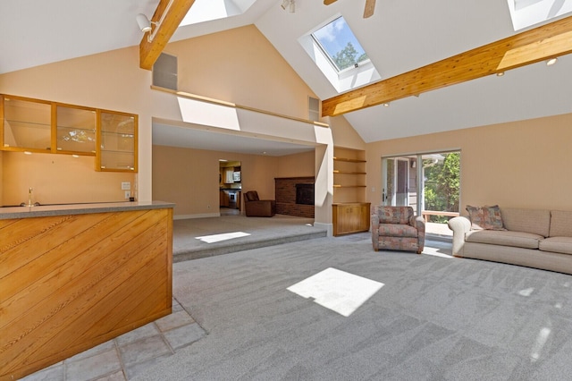 24 High St, Hallowell, ME 04347 - carpeted living room with a skylight, beam ceiling, and high vaulted ceiling