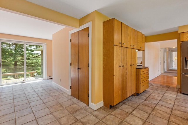 24 High St, Hallowell, ME 04347 - kitchen featuring light tile patterned flooring, stainless steel fridge, and a baseboard radiator