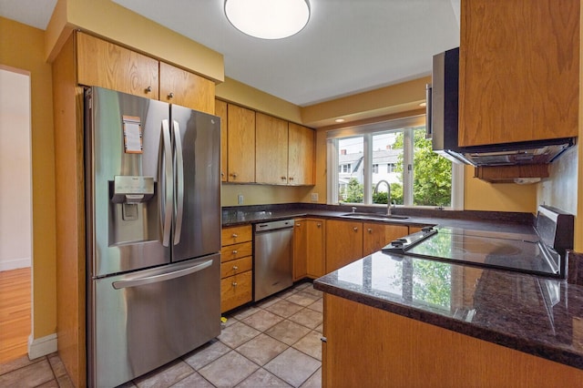 24 High St, Hallowell, ME 04347 - kitchen with stainless steel appliances, dark stone counters, and light tile patterned floors